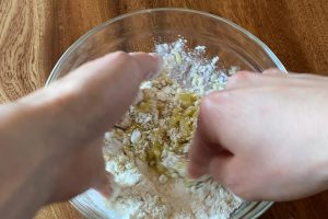 3.別のボウルに地粉と塩を混ぜ合わせオリーブオイルを加えて手ですり合わせます。