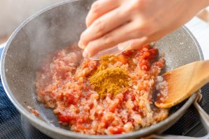 （5）カレー粉を加えて炒め合わせる。