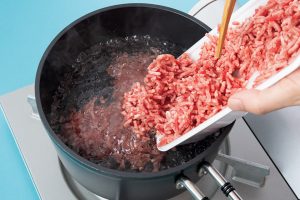 沸騰したら、ひき肉を加える。かたまらないように、箸でよくほぐす。
