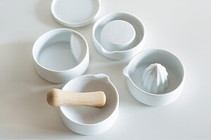 SITAKUのレモン絞り ほか──「道具として使える器」のコンセプトでデザインした有田焼のシリーズ。スタッキング可能（各直径10cm）。レモン絞り5.7cm、すり鉢H3.5cm、お玉立てH3.8cm、おろし器（しょうが）H2.8cm 各1,870円、蓋H1.2cm 660円（キハラ <a href="https://e-kihara.co.jp/" target="_blank">https://e-kihara.co.jp/</a>）