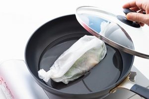【フライパン】フライパンに水カップを入れる。包みを中央に置き、フタをして蒸し煮に。水が減ったら焦げつかないように適宜足す。直径26cmなら包み2個まで可能。
